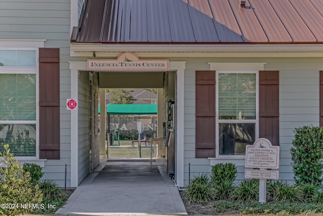 property entrance featuring a standing seam roof and metal roof