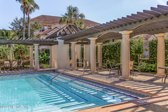 view of pool with a pergola and a patio