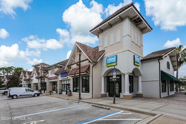 view of building exterior featuring uncovered parking