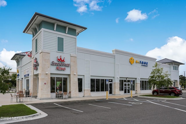 view of building exterior featuring uncovered parking