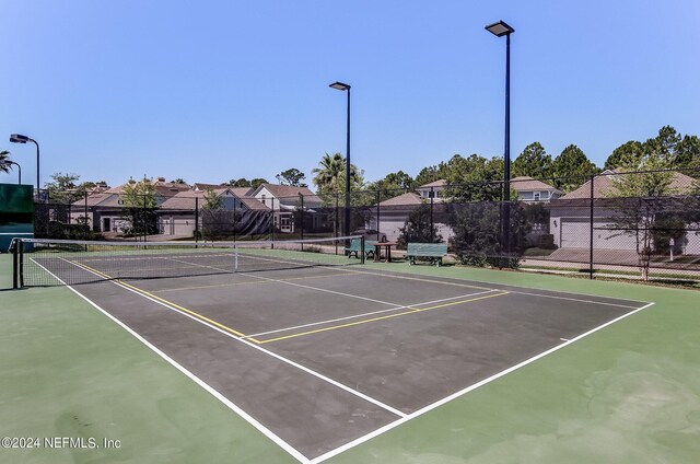 view of sport court with basketball hoop