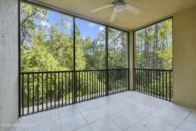 unfurnished sunroom with ceiling fan