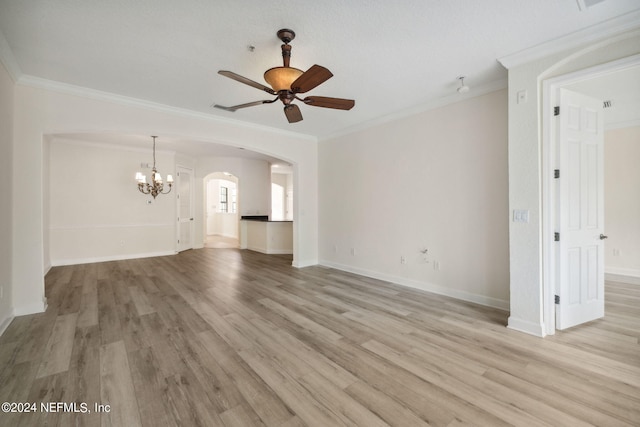 unfurnished living room with light wood-style floors, arched walkways, crown molding, and ceiling fan with notable chandelier