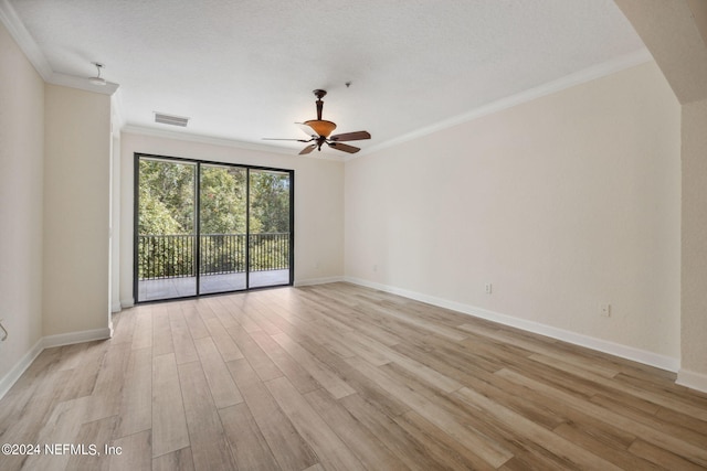 empty room with a textured ceiling, ceiling fan, crown molding, and light hardwood / wood-style flooring