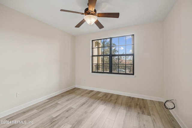 unfurnished room with a ceiling fan, baseboards, and light wood finished floors