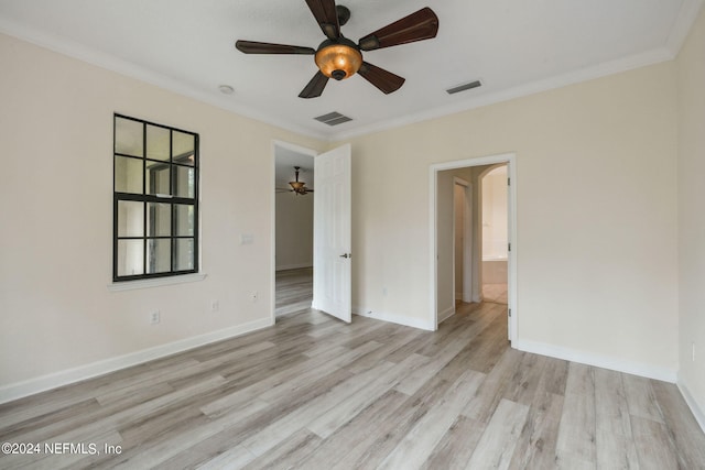 spare room with light wood-type flooring, ceiling fan, and crown molding