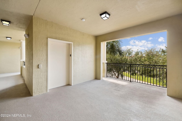 balcony featuring elevator and a patio area