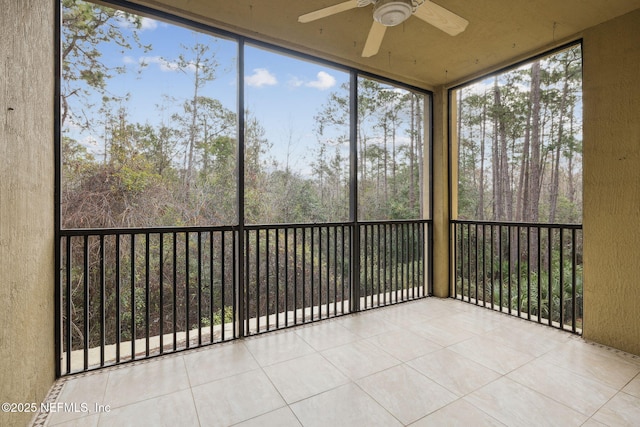 unfurnished sunroom featuring ceiling fan