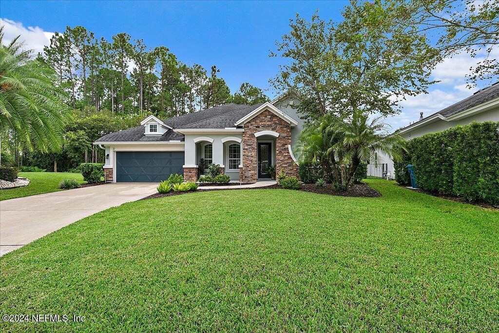 view of front facade with a garage and a front lawn