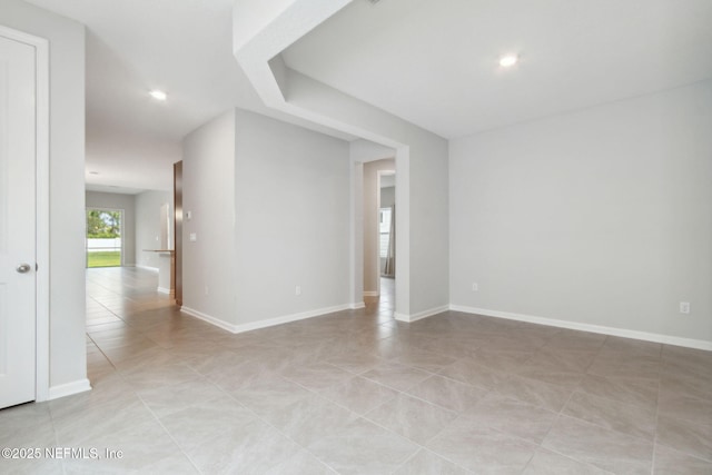 unfurnished room featuring light tile patterned floors, recessed lighting, and baseboards