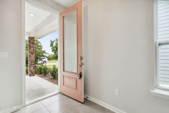 entryway featuring light tile patterned floors and baseboards