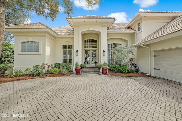 exterior space featuring french doors and a garage