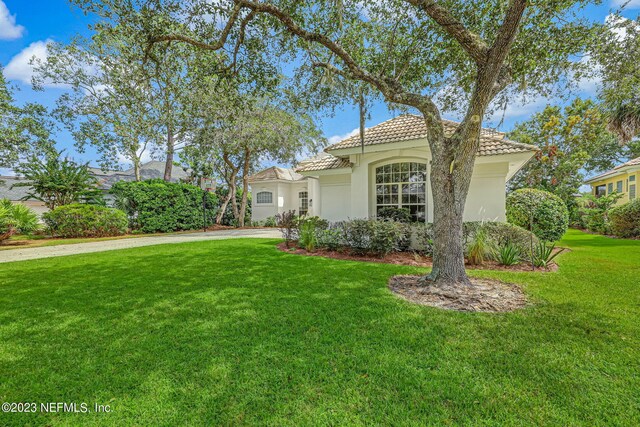 mediterranean / spanish-style house with a front yard