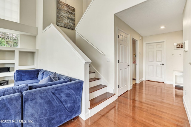 interior space with a high ceiling and hardwood / wood-style flooring