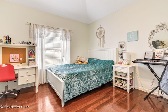 bedroom featuring hardwood / wood-style floors and vaulted ceiling