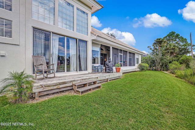 view of yard with a deck and a sunroom