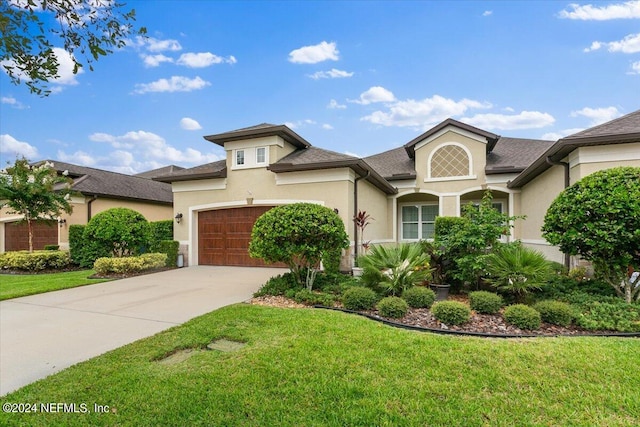 view of front of home featuring a garage and a front lawn