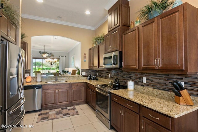 kitchen featuring decorative backsplash, appliances with stainless steel finishes, light stone countertops, sink, and light tile patterned flooring