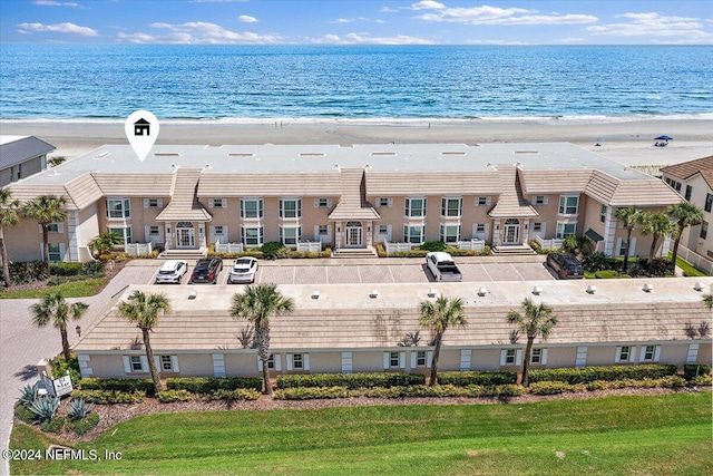 drone / aerial view with a beach view and a water view