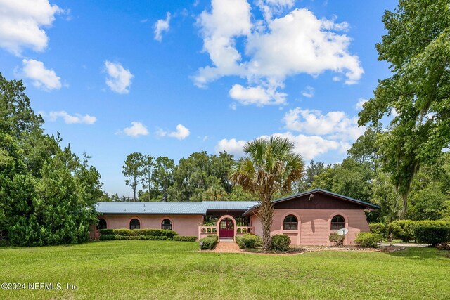 ranch-style house with a front lawn