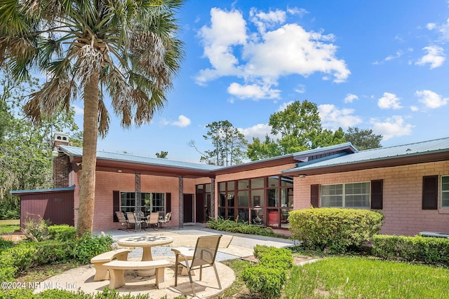 back of property featuring a patio