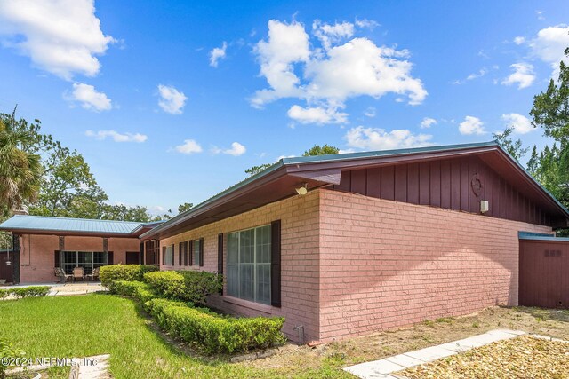 view of property exterior with a patio