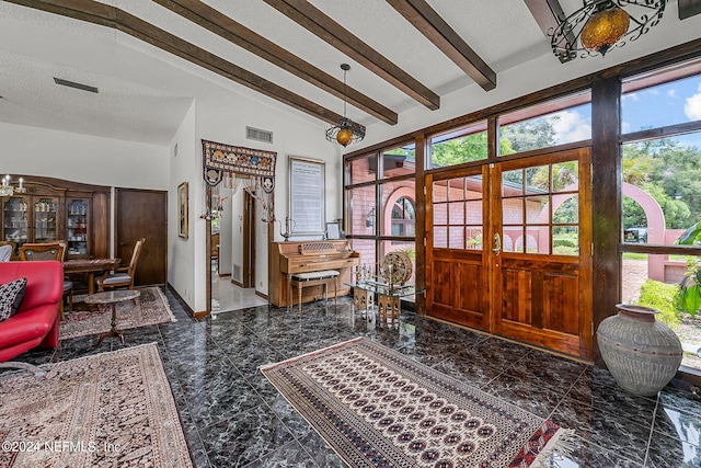 entrance foyer featuring tile patterned flooring and lofted ceiling with beams