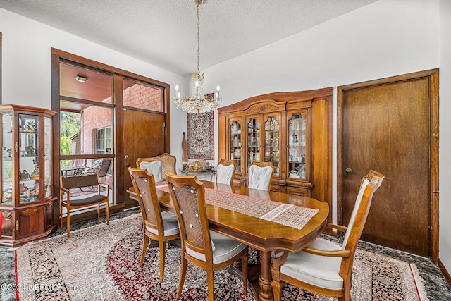 dining room featuring a textured ceiling and a chandelier