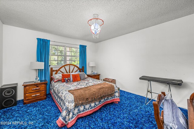 carpeted bedroom featuring a textured ceiling