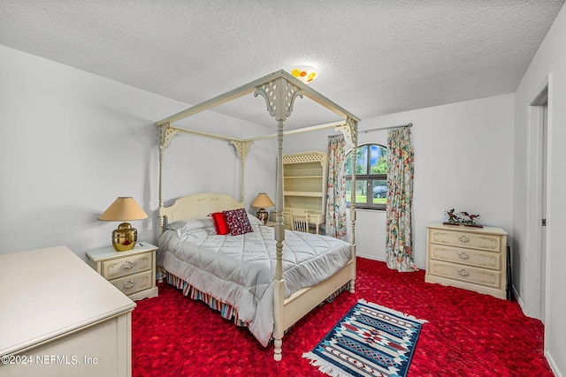 bedroom with a textured ceiling and carpet floors