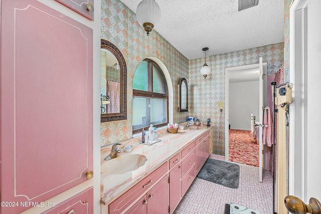 bathroom featuring tile patterned flooring, a textured ceiling, and vanity