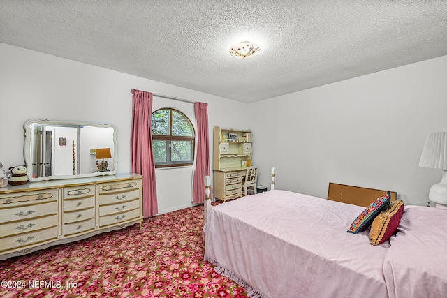 carpeted bedroom with a textured ceiling