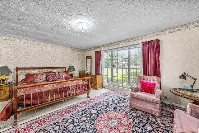 bedroom with a textured ceiling and light carpet