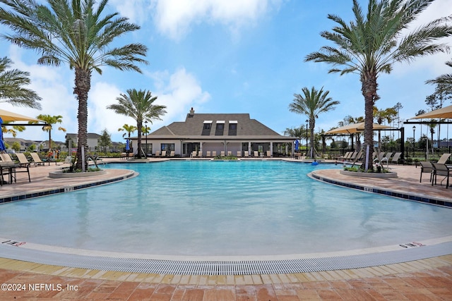 pool featuring a patio area and fence