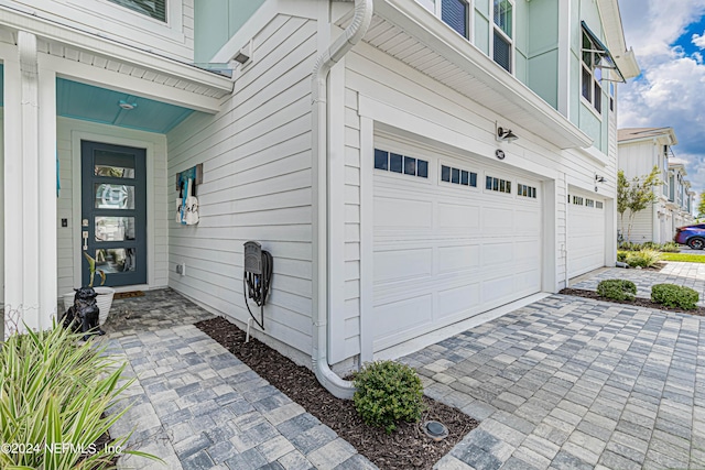 view of exterior entry with decorative driveway