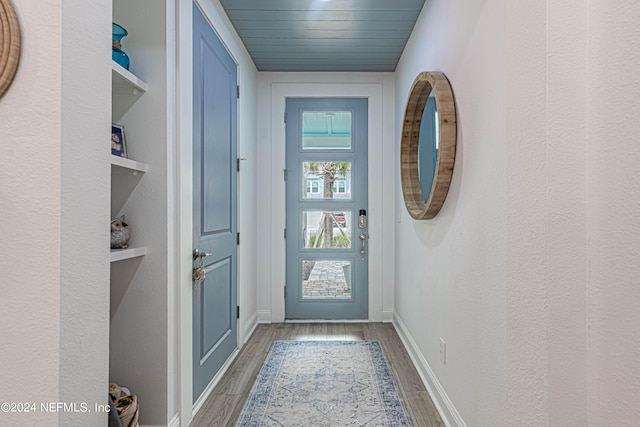 entryway featuring baseboards and light wood finished floors