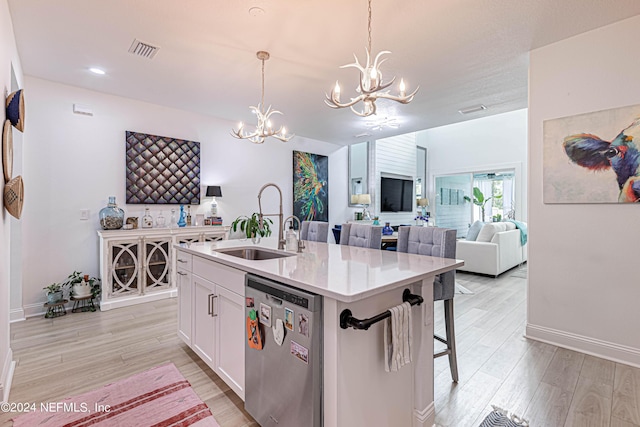 kitchen featuring light wood-style floors, visible vents, dishwasher, white cabinets, and a notable chandelier