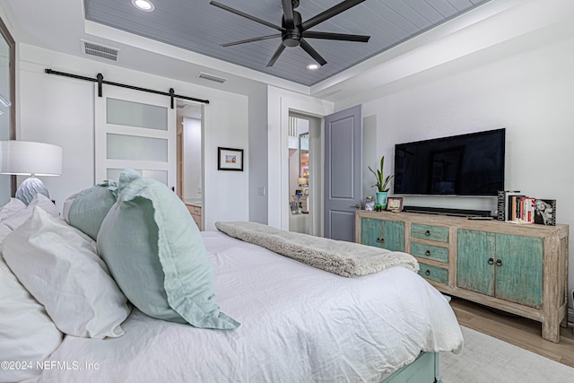 bedroom featuring visible vents, wood finished floors, recessed lighting, a barn door, and wooden ceiling
