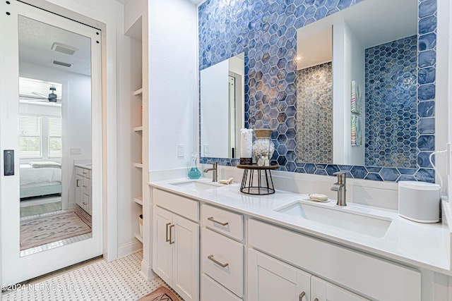 ensuite bathroom with double vanity, a sink, ensuite bathroom, and ceiling fan