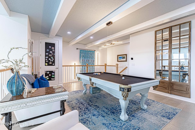 game room featuring recessed lighting, a textured ceiling, beamed ceiling, pool table, and wood finished floors