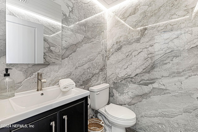 bathroom featuring toilet and vanity
