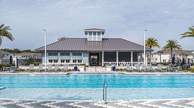 community pool with fence and a patio