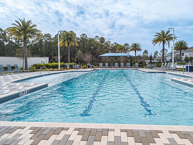 pool with fence and a patio area