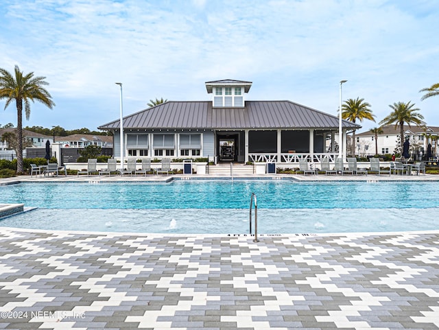 pool featuring fence and a patio area