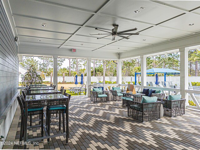 view of patio featuring outdoor lounge area, ceiling fan, and fence