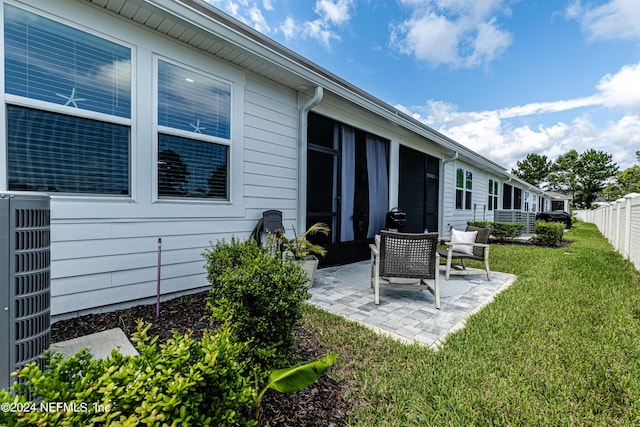 exterior space featuring central AC and fence