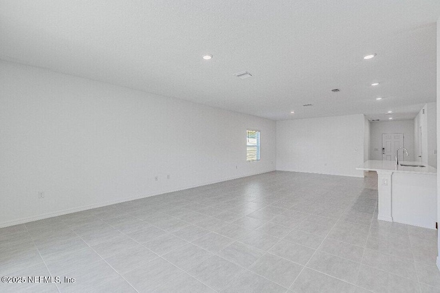 unfurnished living room with sink