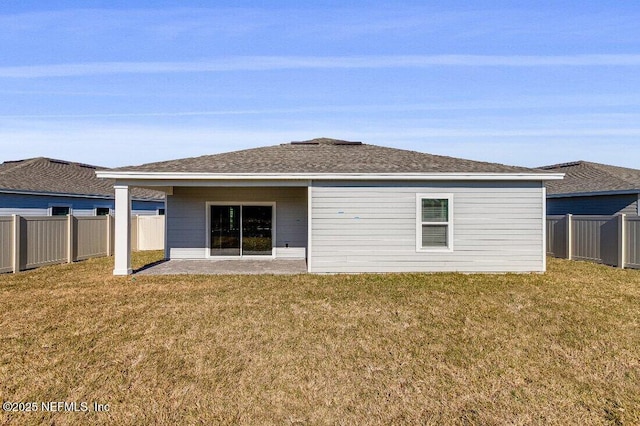 rear view of house featuring a yard and a patio area