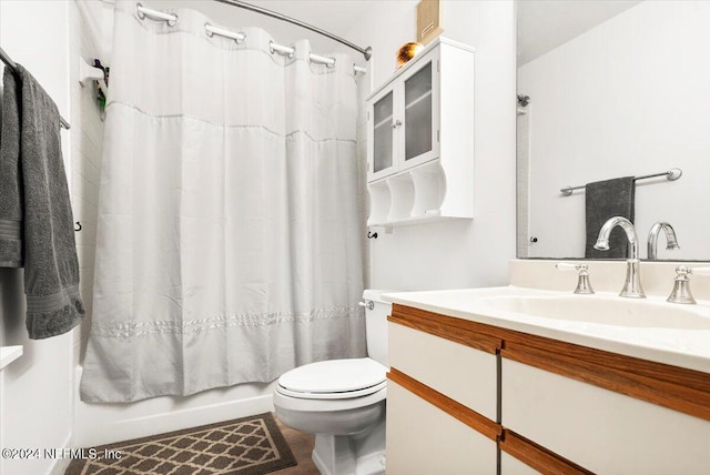 full bathroom with vanity, shower / bath combo, and toilet