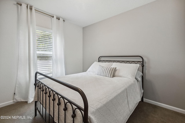 carpeted bedroom featuring baseboards